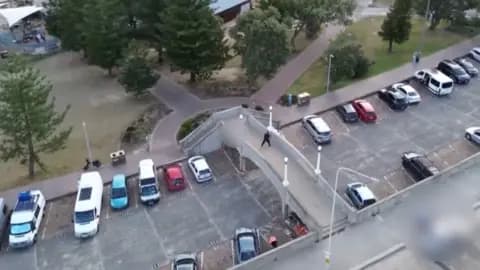 An aerial view of a bridge over a carpark