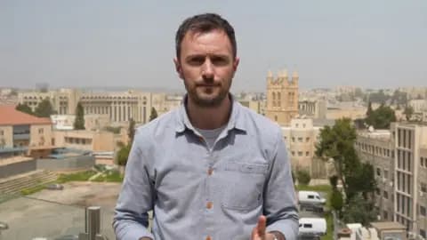 BBC journalist Joel Gunter in a blue shirt
