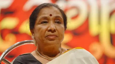 Asha Bhosle wearing an off-white saree and a red bindi in Mumbai in 2008