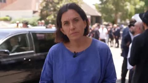 BBC correspondent Katy Watson standing outside funeral in Bondi next to mourners gathering on the street
