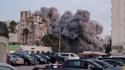 A building collapses in a pile of dust