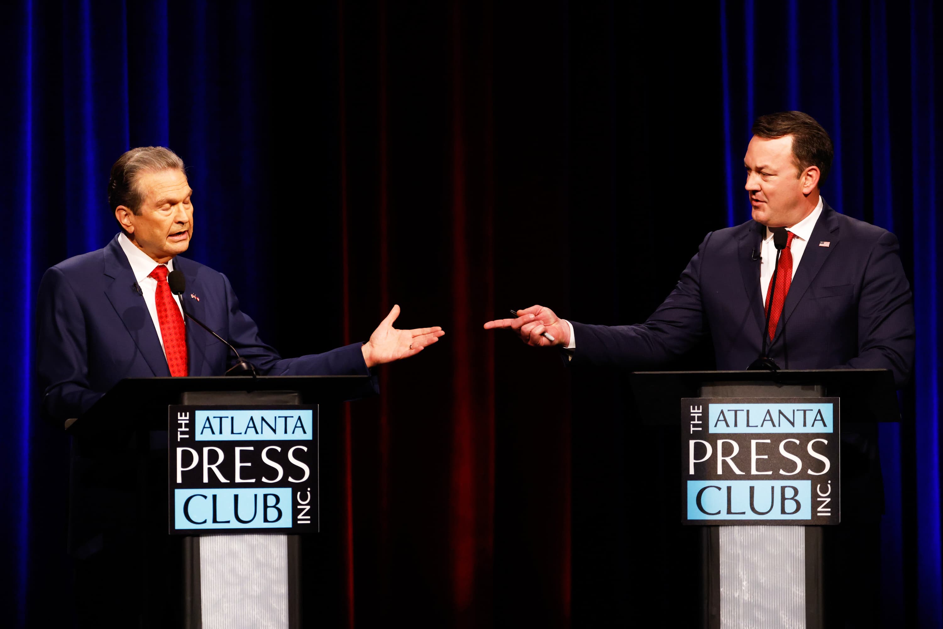Gubernatorial candidates Rick Jackson, left, and Burt Jones interact at the Atlanta Press Club Loudermilk-Young Republican primary election debate in Atlanta, on April 27, 2026.