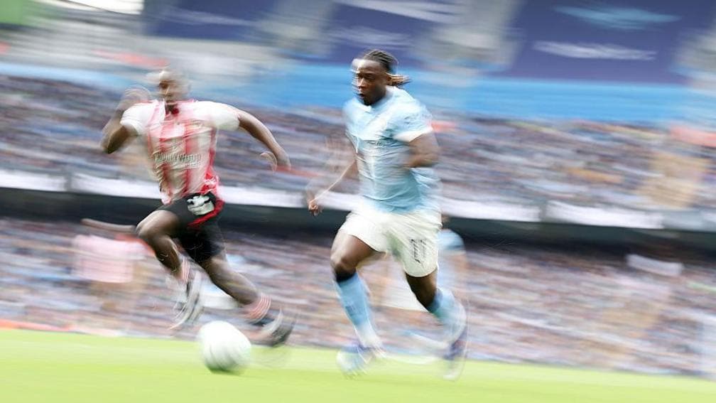 Jeremy Doku running past his full-back in a Premier League match between Manchester City and Brentford at Etihad Stadium