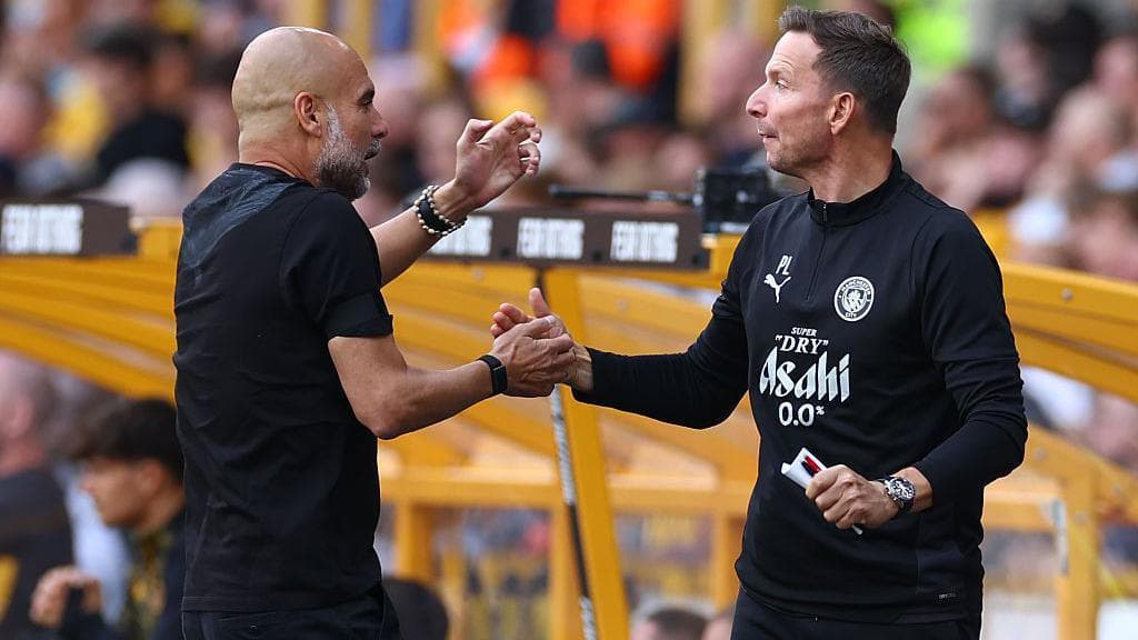 Manchester City Manager Josep Guardiola celebrates a goal with assistant first team coach Pepijn Lijnders during the Premier League match between Wolverhampton Wanderers and Manchester City at Molineux on August 16, 2025 in Wolverhampton, England