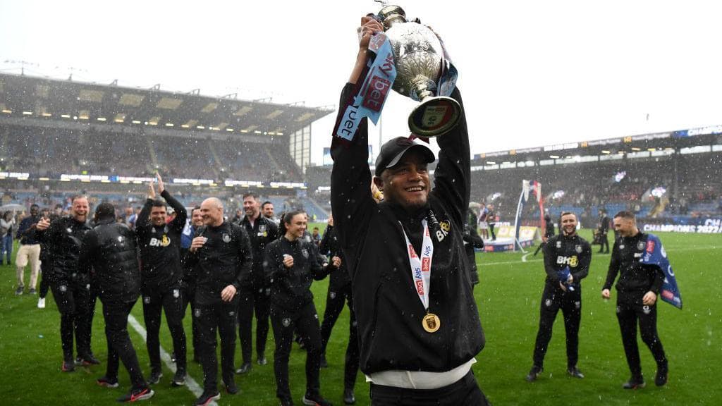 Image of Vincent Kompany, when managing Burnley celeberating winning the Championship and lifting the trophy.