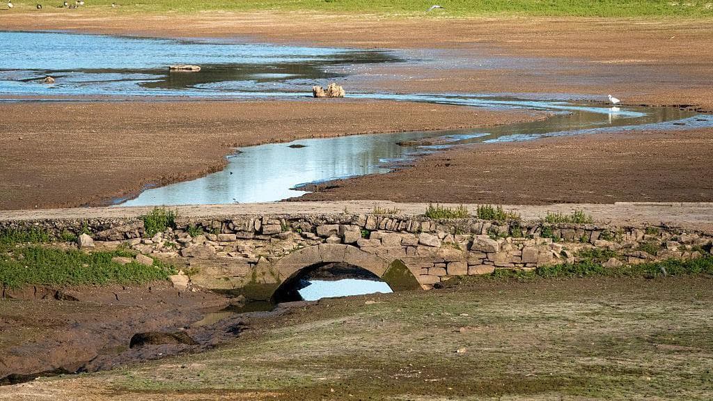Low water levels at Chew Valley lake reservoir, exposing cracked ground and a old bridge on September 6, 2025 near Bristol, England.