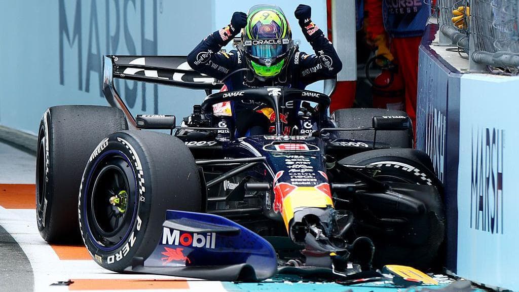 Isack Hadjar clenches his fists and prepares to bang them on his damaged Red Bull after crashing out of the Miami Grand Prix