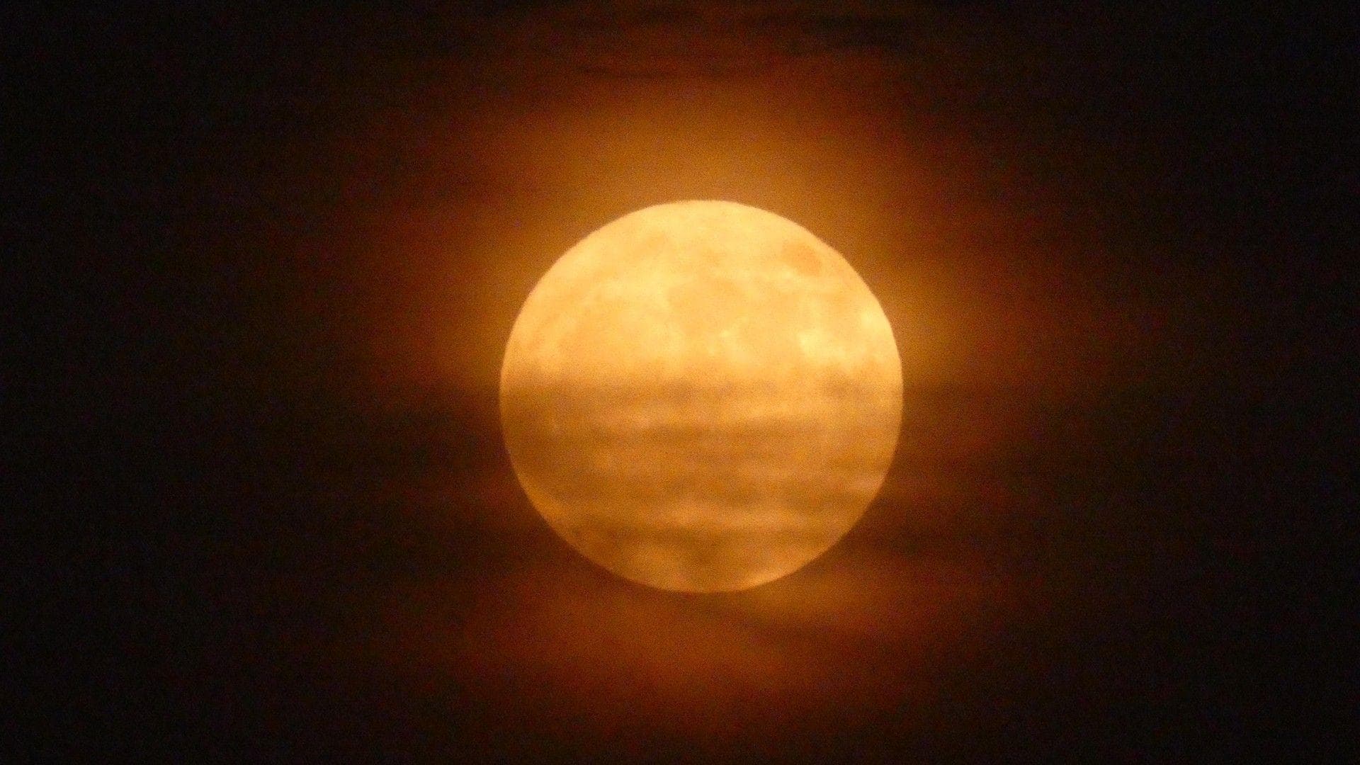 Full moon through wispy clouds