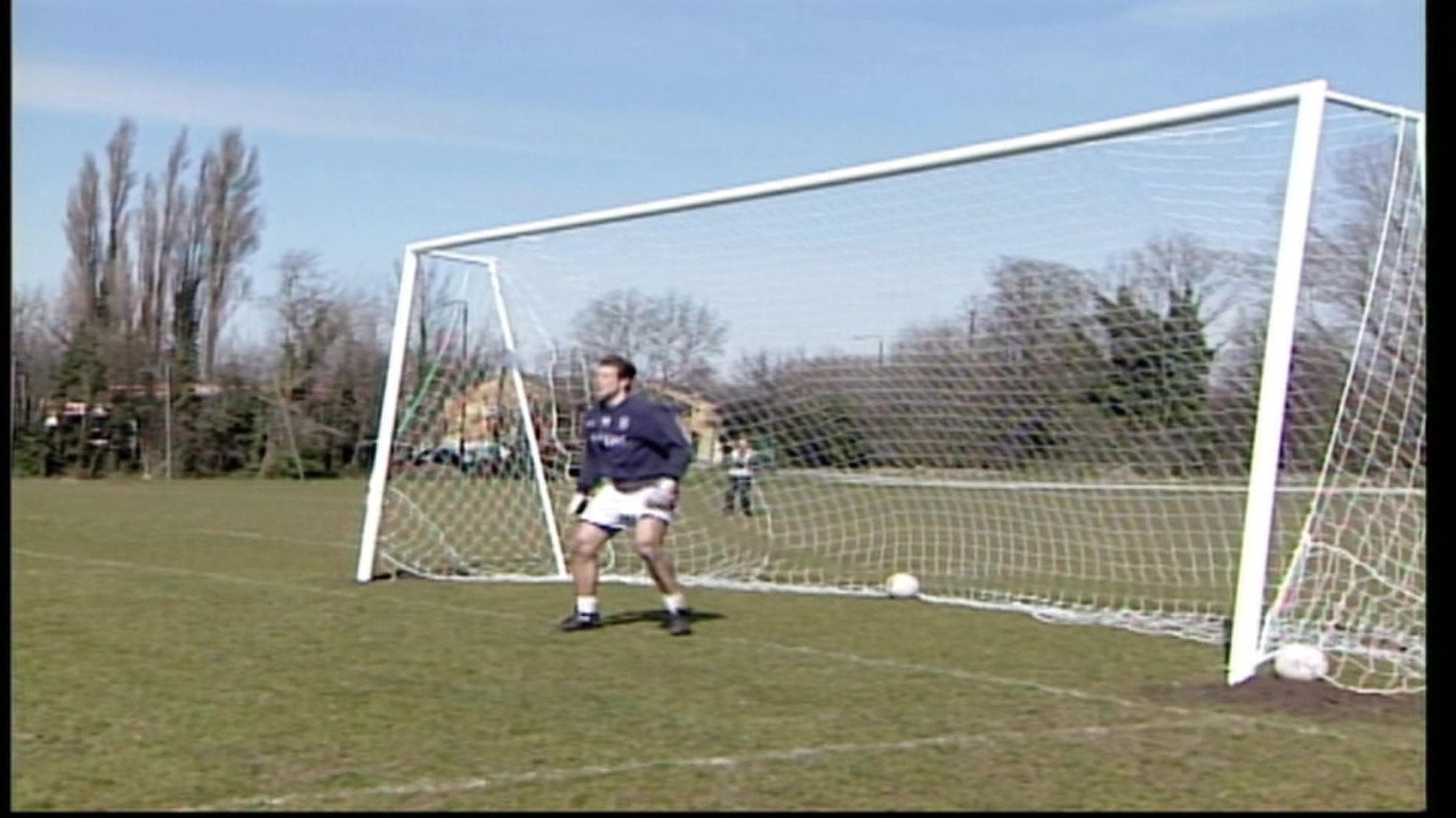 A picture of a goalkeeper stood in an oversized goal