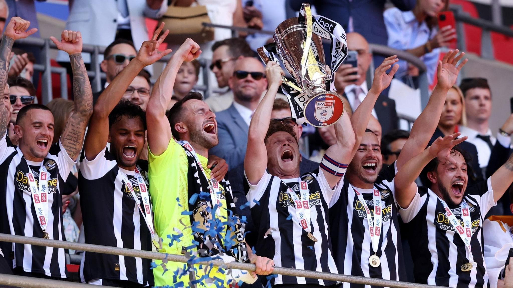 Notts County players lift the League Two play-off final trophy at Wembley