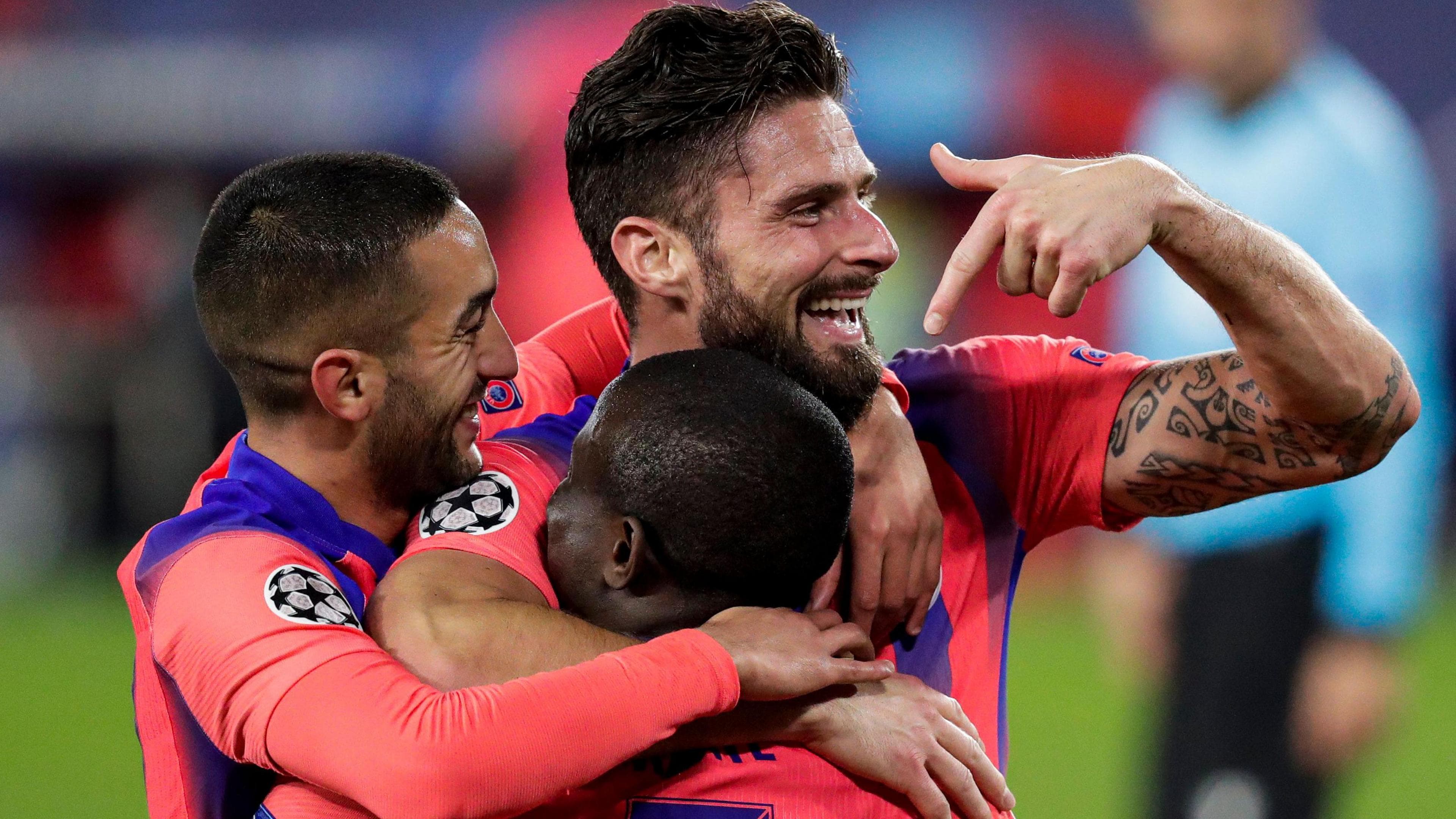 Giroud celebrates with Hakim Ziyech and N'Golo Kante after his third goal against Sevilla in 2020. Kante had provided the cross for Giroud's header that completed his hat-trick, and he scored all four of Chelsea's goals that night