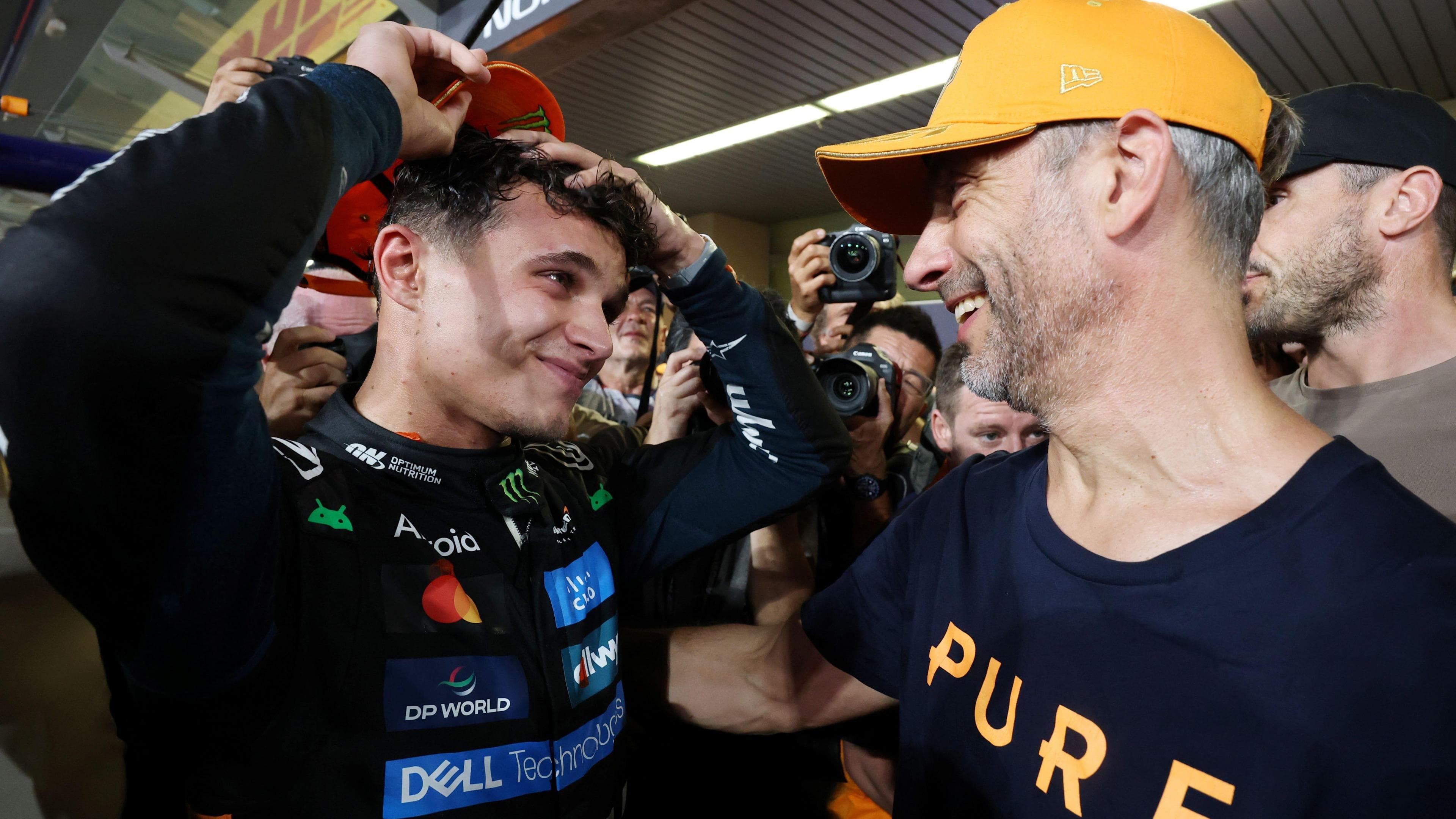 Adam Norris congratulates his son Lando after he won the 2025 F1 drivers' championship at the Abu Dhabi Grand Prix