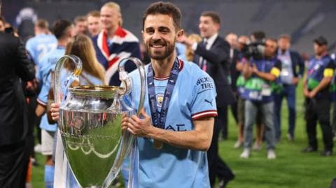 Bernardo Silva holds the Champions League trophy