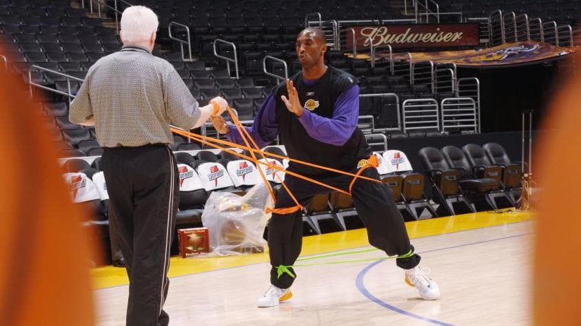 Alex McKechnie uses elastics to work with Kobe Bryant