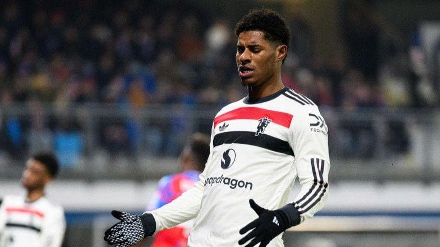 Marcus Rashford playing for Manchester United in a largely white change kit
